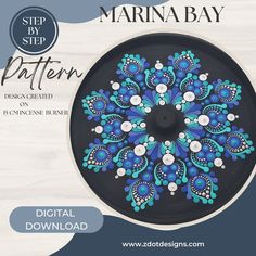 a black plate with blue and white flowers painted on it's side is featured in the step by step pattern book