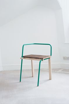 a chair sitting in the middle of a room next to a radiator and window