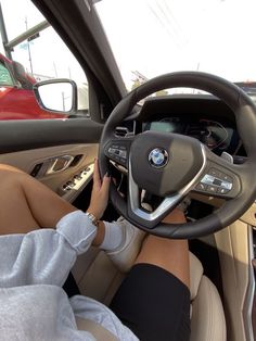 a woman sitting in the driver's seat of a car