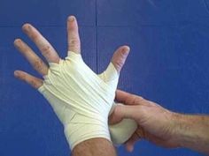 a hand with bandages on it is being held up by someone's arm and thumb