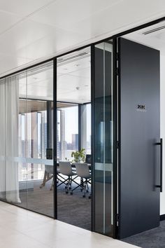 an office with glass walls and sliding doors