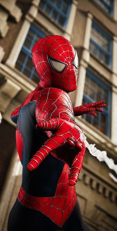 a statue of spider - man in front of a building