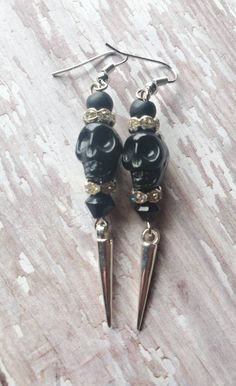 FREE DOMESTIC SHIPPING ONLY Please read the shipping, policies, and procedures Personal handmade fave! Spooky cool black skull earrings accompanied by matte black rounds, diamond-like crystal rondelles, and glass jet black bicone with silver dangling spikes. The earrings dangle at 2.75 inches (1cm in width), very light weight. The black skulls have intricate detailing and the earrings are created with silver tone plated precious metals. These earrings make a great fashion statement, especially f Edgy Pierced Halloween Earrings, Edgy Pierced Earrings For Halloween, Edgy Halloween Pierced Earrings, Nickel-free Gothic Black Plug Earrings, Gothic Black Nickel-free Plug Earrings, Nickel-free Black Punk Earrings, Black Nickel-free Punk Earrings, Adjustable Black Skull-shaped Earrings, Handmade Black Halloween Earrings