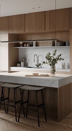 a kitchen with two stools next to an island