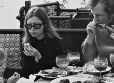 three people sitting at a table eating food