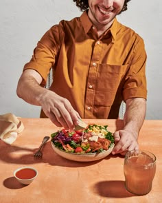 a man sitting at a table with a plate of food