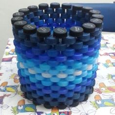 a stack of blue and black plastic cups sitting on top of a table