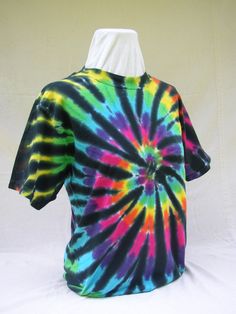 a colorful tie - dyed shirt is displayed on a mannequin's head