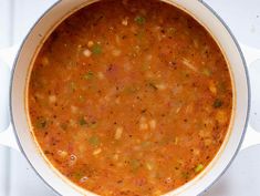 a pot filled with soup sitting on top of a stove