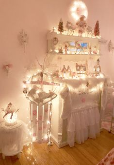 a baby's room decorated in pink and white with fairy lights on the wall