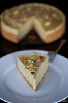 a slice of cheesecake on a plate with a fork