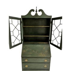 an old green dresser with two open doors