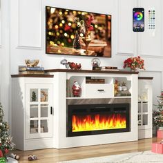 a living room with christmas decorations and a fire place in the center, tv on