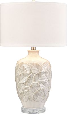 a white ceramic lamp with a white shade