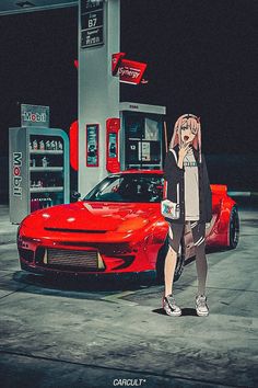 a woman standing next to a red sports car in front of a gas station at night