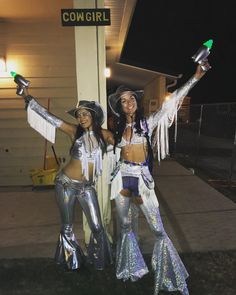 two women dressed in costumes posing for the camera