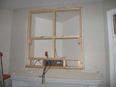 an unfinished window is being installed in the corner of a room with white walls and wood trim