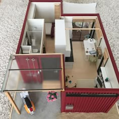 an overhead view of a small house with the living room and kitchen visible from above