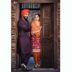 a man and woman standing in an open doorway