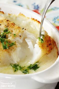 a close up of a bowl of food with a spoon sticking out of the top