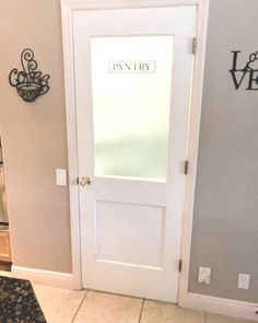 a white door with the word pantry written on it