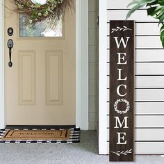 a welcome sign sitting next to a door