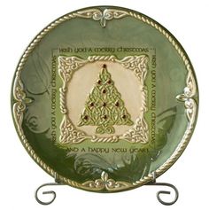 a green plate with a christmas tree on the front and sides, hanging from a metal hook