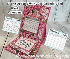 a pink and white calendar sitting inside of an open box on top of a wooden table