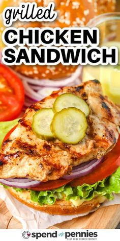 grilled chicken sandwich with tomatoes, cucumber and lettuce on the side