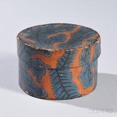 an orange and blue box sitting on top of a white table