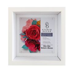 the paper flowers are arranged in a white frame