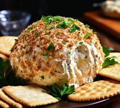 a cheese ball with crackers and parsley sprinkled around it on a plate