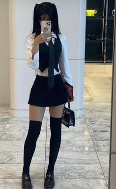 a woman in short skirt and tie taking a selfie