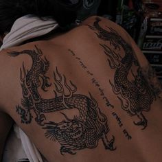 a man with a dragon tattoo on his back