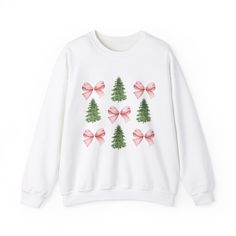 Embrace the cozy charm of the season with this cozy Crewneck Sweatshirt, adorned with delightful trees and ribbons. Perfect for holiday gatherings, cozy nights in, or a casual outing. This sweatshirt radiates warmth and style, creating an inviting atmosphere wherever you go. It's ideal for those who appreciate comfort and sustainability, making it a great gift for friends and family. Celebrate the festive spirit, whether for Christmas, Thanksgiving, or casual winter days. Designed for anyone seeking a blend of style and coziness, this sweatshirt will be a staple in your wardrobe during the colder months. Product features - Knit in one piece without side seams, reducing fabric waste. - Highly elastic ribbed knit collar retains its shape. - Cozy medium-heavy fabric blend of 50% cotton and 50 Cute Winter Shirts, Christmas Crewneck Sweatshirt, Winter Apparel, Christmas Crewneck, Winter Shirts, Cozy Gift, Holiday Sweatshirt, Christmas Tree Design, Tree Design