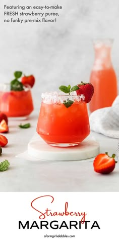 strawberry margarita cocktail in a glass with strawberries on the rim