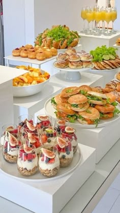 an assortment of sandwiches and desserts on display