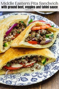 two pita sandwiches on a blue and white plate