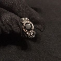 a close up of a person's hand with a ring on top of it