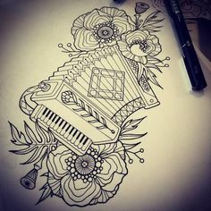 a drawing of a musical instrument with flowers on the side and a pen resting next to it