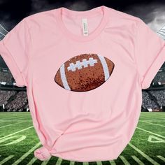 You are going to love this Sequin Football Tshirt!   A great shirt for the entire football season.   Awesome for a Football Mom Shirt and more.  In a choice of shirt colors, you can't go wrong! Large Sequin football at appx. 9 3/4 inches. Makes a great group shirt too! >Click on the drop down menu to see size and color options. >High end super soft and comfy tee. > Comes in a variety of shirt color options.  (Red, White, Navy, Heather Peach, Pink, Heather Green and Black.) > Sequin Football is a Football Season Tops With Team Logo For Sports Fans, Football Season T-shirt With Team Logo, Sports Fan Tops With Team Logo For Football Season, Football Season Team Logo T-shirt, Football Season Fan Gear Shirt, Football Season Fan Apparel Short Sleeve Shirt, Game Day Pre-shrunk Shirt For Sports Season, Pre-shrunk Football Season Sports Fan Shirt, Football Season Sports Fan T-shirt With Screen Print