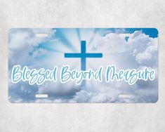 a blue cross with the words, blessed beyond meagate on it in front of clouds