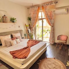 a bedroom with a large bed and wooden floors