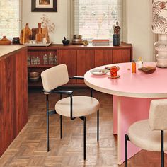 a pink table and chairs in a room