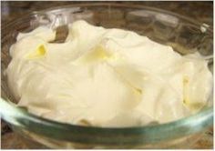 a bowl filled with cream sitting on top of a table