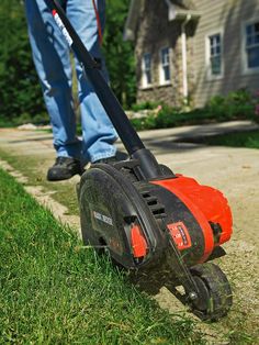 a man is using a lawn mower to cut the grass