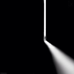 an open door with light coming in from behind it on a black background and floor