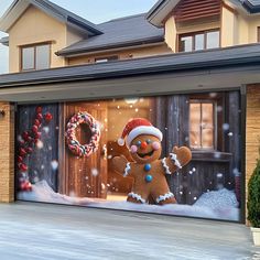 a garage door decorated with a christmas scene and a gingerbread man standing in front of it