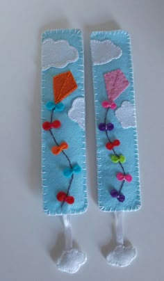 two bookmarks made to look like they have kites and flowers on the ends