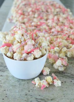 pink and white party popcorn in a bowl